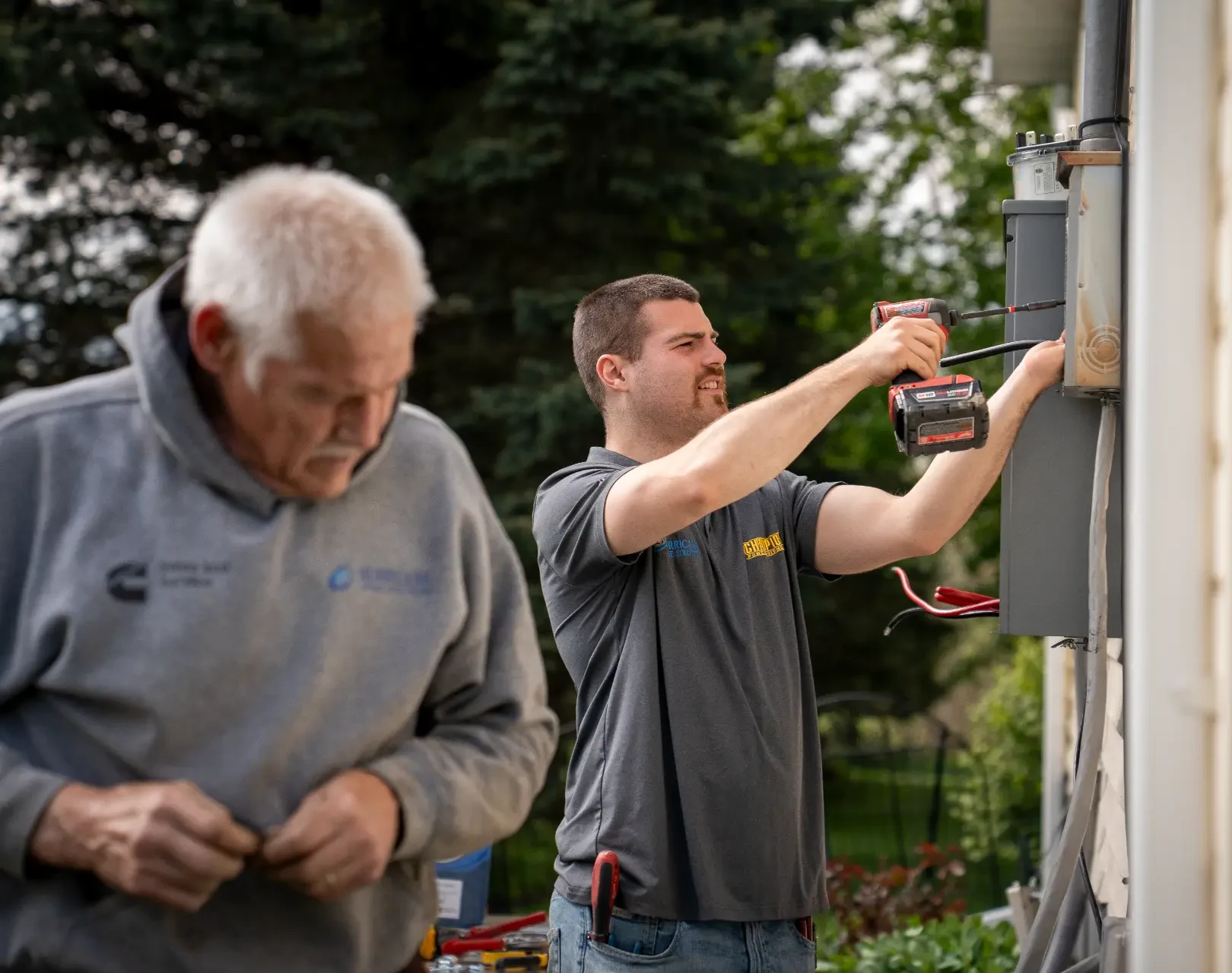 Hurricane Generators technicians wiring a transfer switch during a home standby generator installation